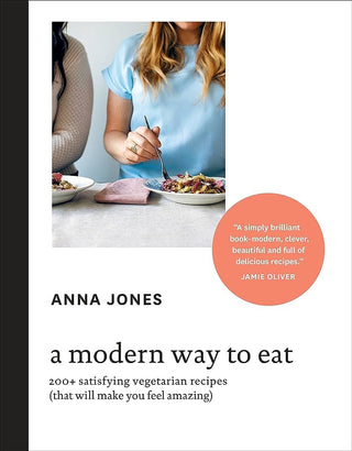 Book cover of 'A Modern Way to Eat' by Anna Jones with a photo of two people eating.