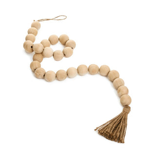 Wooden bead necklace with tassel on a white background