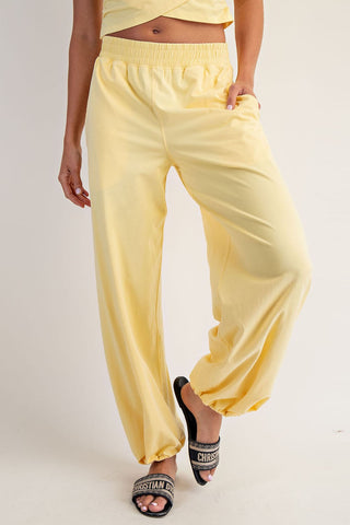 Person wearing yellow pants on a plain background