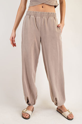 Beige wide-leg pants worn by a person on a white background