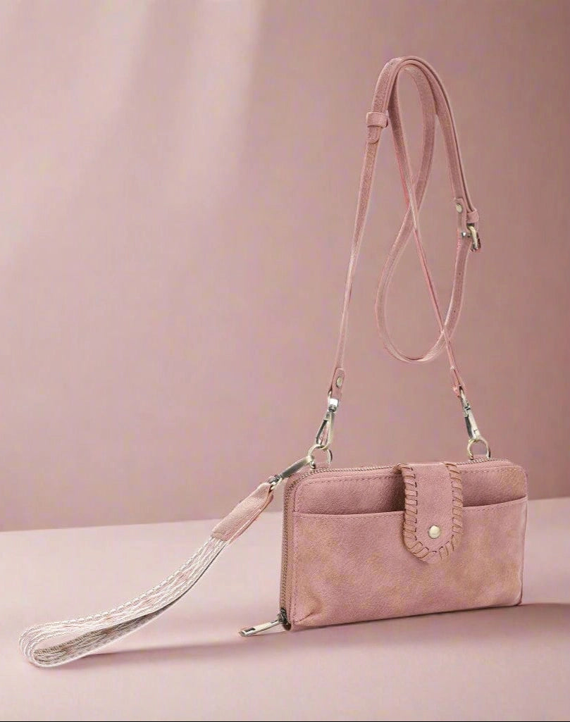 a pink velvet wallet purse with a boho guitar strap.