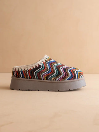 Multicolored zigzag patterned slip-on shoe on a beige background
