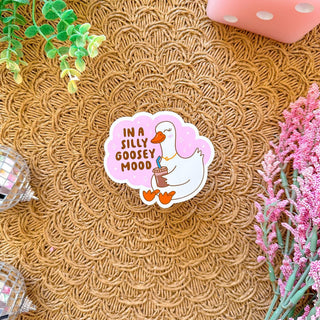 Stickers with a quote 'What a good day to be proud of the progress you've made' on a pink background with confetti and decorative items around.