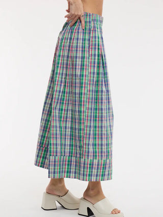 Multicolored plaid skirt worn by a person on a white background