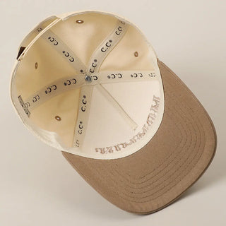 Baseball cap with beige interior and brown exterior on a light gray background