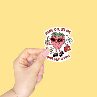 a hand holding a sticker with the phrase hang on, let me girl math this