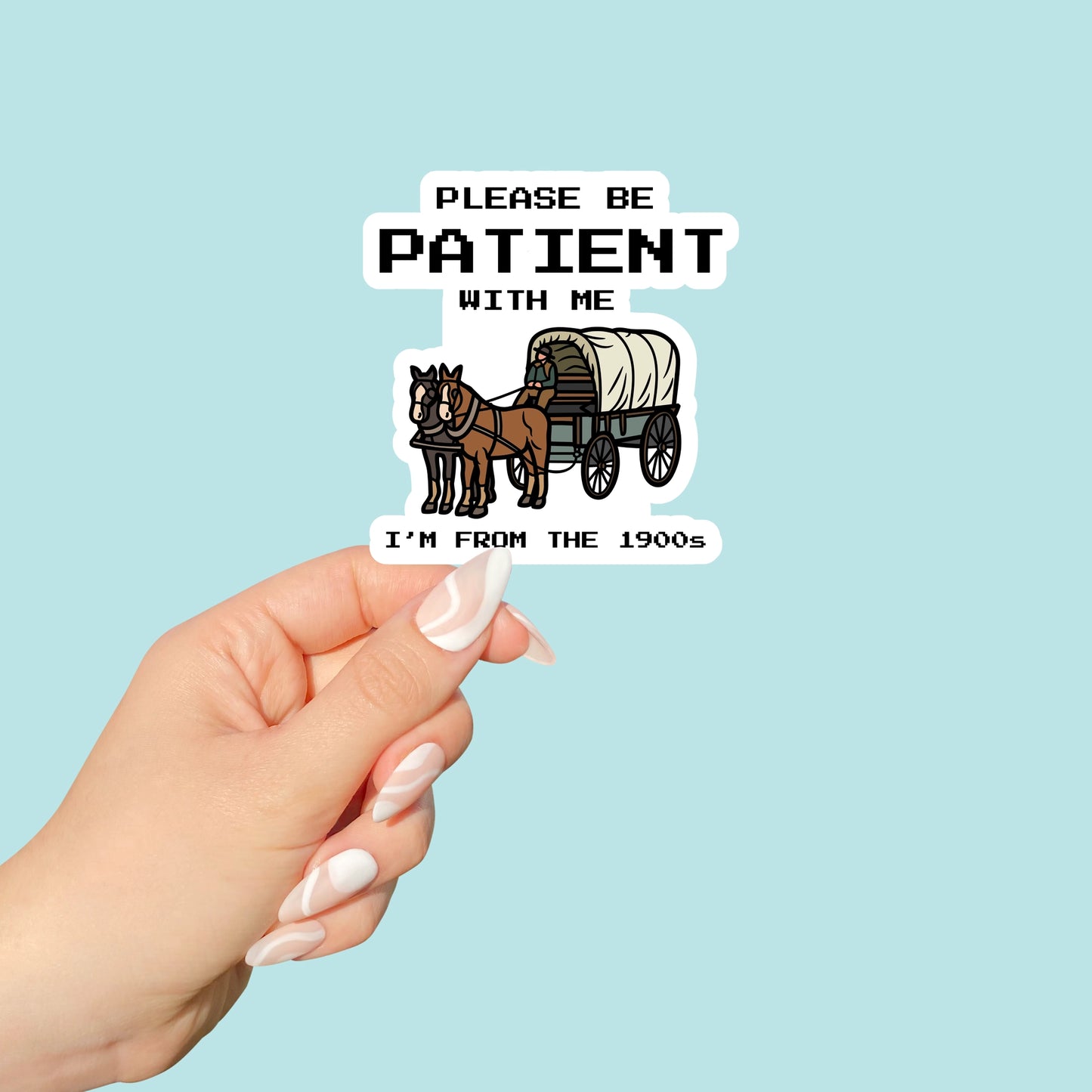 Hand holding a sticker with a horse-drawn carriage and text on a light blue background