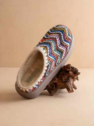 Multicolored zigzag patterned slipper on a beige background