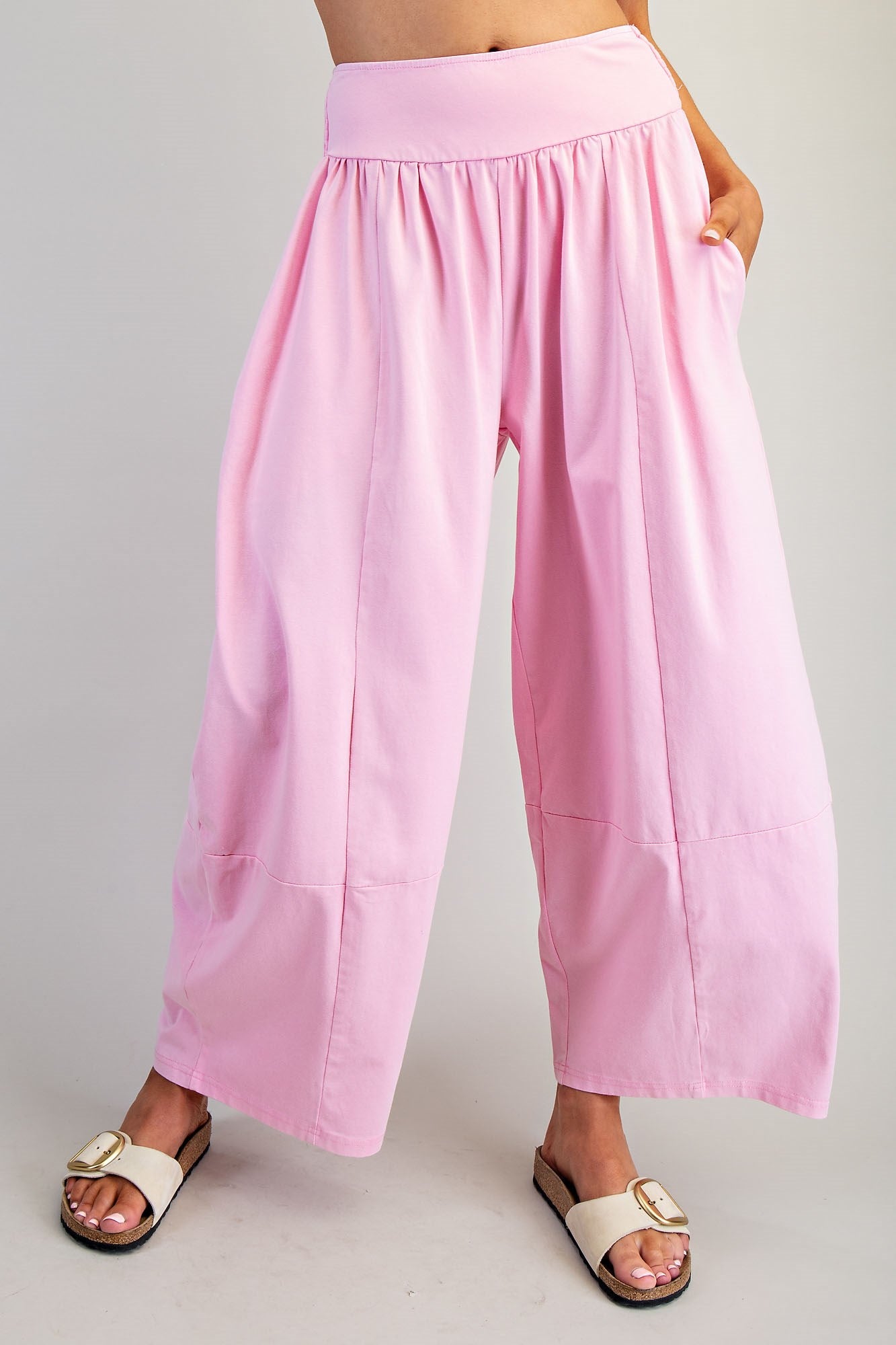 Pink wide-leg pants worn by a person on a plain background