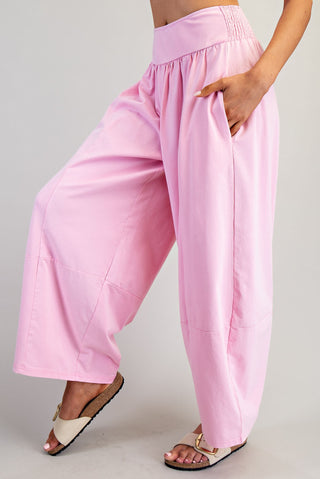 Pink wide-leg pants worn by a person on a plain background