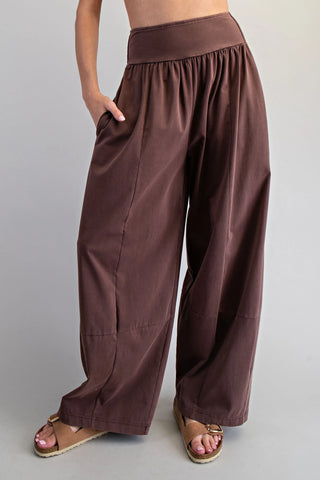 Brown wide-leg pants worn by a person on a plain background