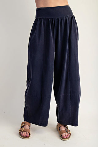 Navy blue wide-leg pants worn by a person on a plain background