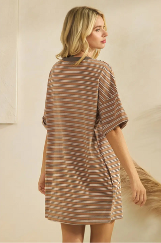 Women wearing a striped t-shirt dress against a neutral background.