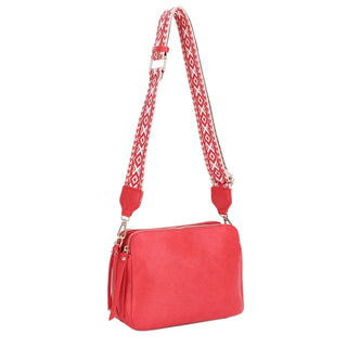 A 3 compartment crossbody bag with a boho guitar strap.