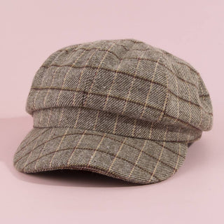 Plaid cap on a pink background