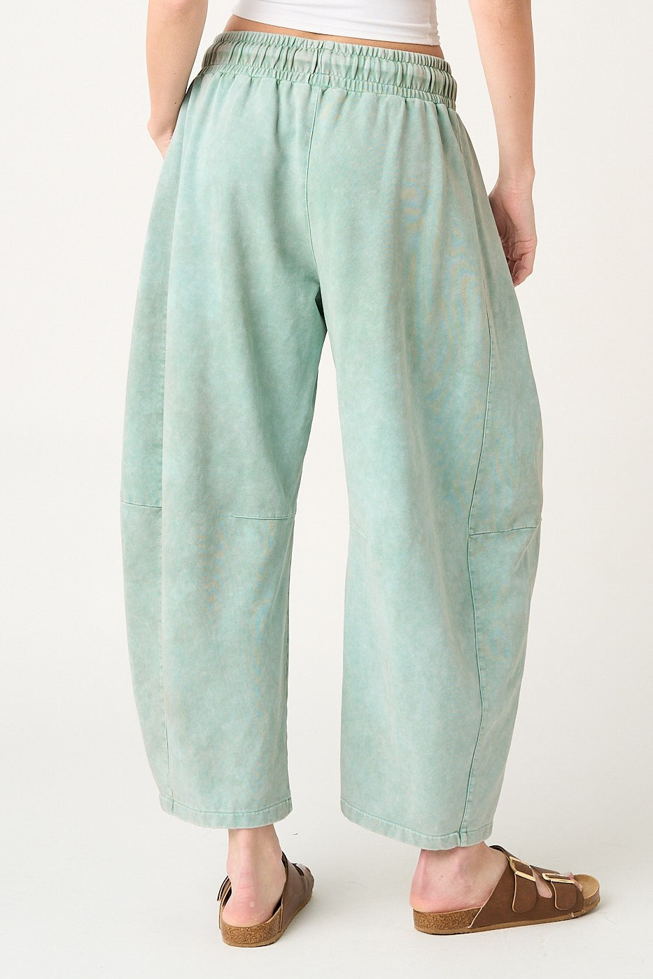 Light blue pants worn by a person on a white background