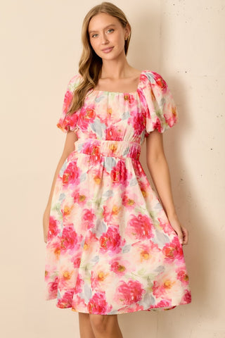 Woman wearing a floral dress against a beige background