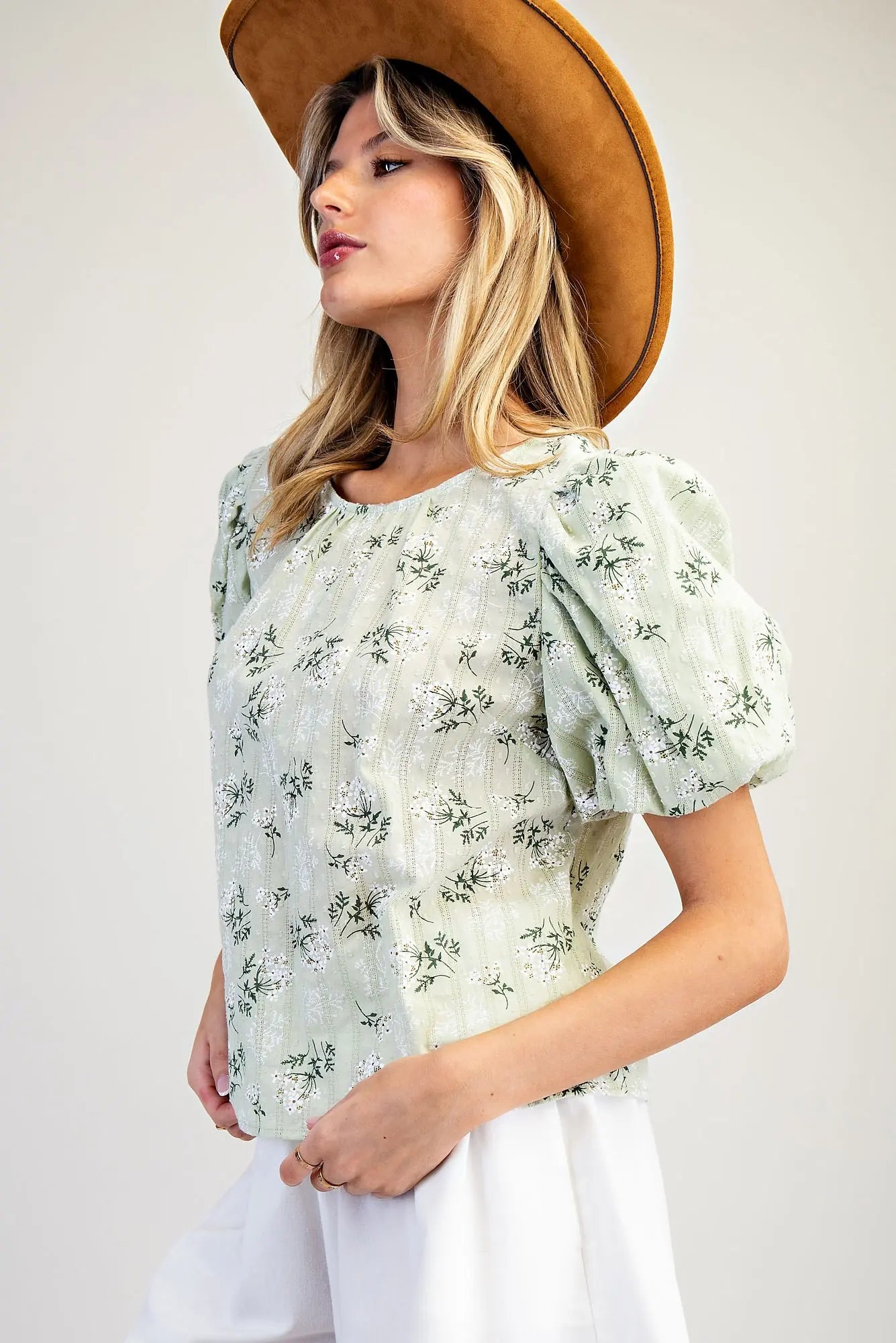 Women wearing a green floral blouse with white shorts