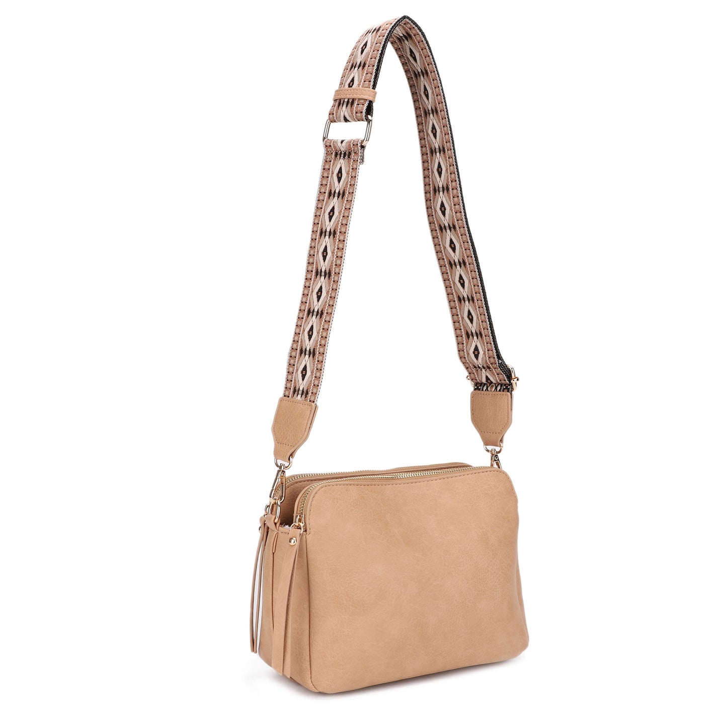 A 3 compartment crossbody bag with a boho guitar strap.