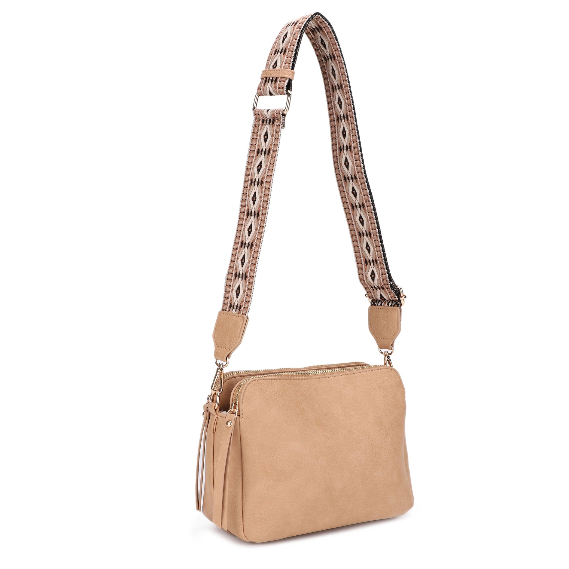 A 3 compartment crossbody bag with a boho guitar strap.