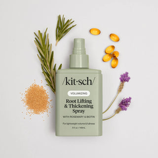 Kit-sch root lifting and thickening spray bottle with botanical elements on a light background