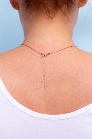 women wearing a necklace showing the back clasp