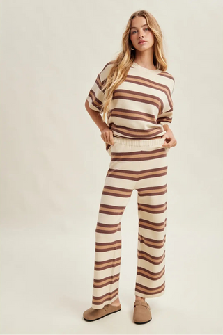 Women wearing a striped matching set against a neutral background.