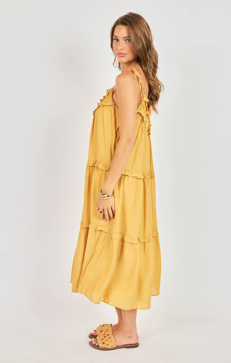 Woman wearing a yellow dress on a white background