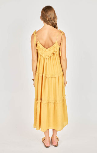 Woman wearing a yellow dress with a white background