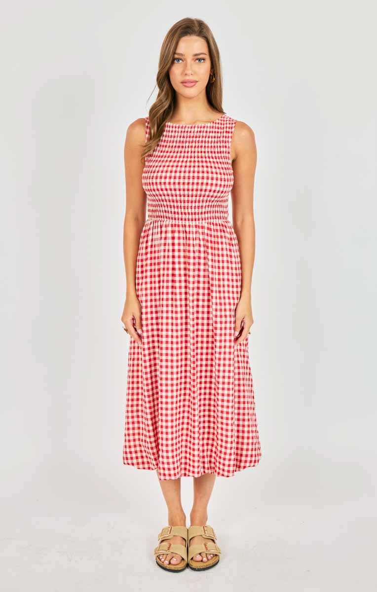Woman wearing a red and white checkered dress on a white background