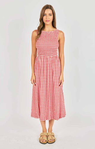Woman wearing a red and white checkered dress on a white background