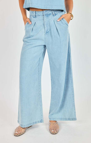 Light blue denim pants worn by a person on a white background
