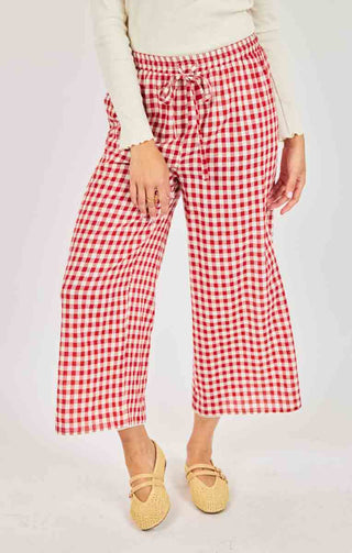 Red and white checkered pants worn by a person on a plain background