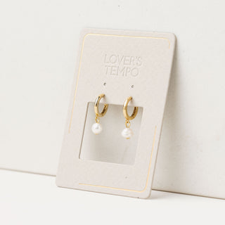 Gold hoop earrings with pearls on a 'Lover's Tempo' branded card.