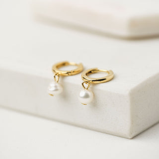 gold hoop earrings with a pearl drop charm