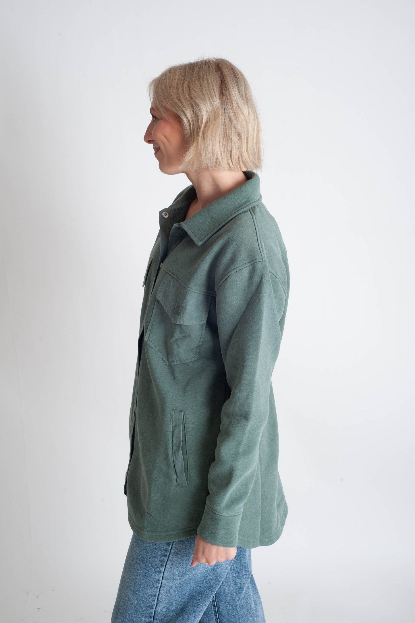 Person wearing a green jacket on a white background