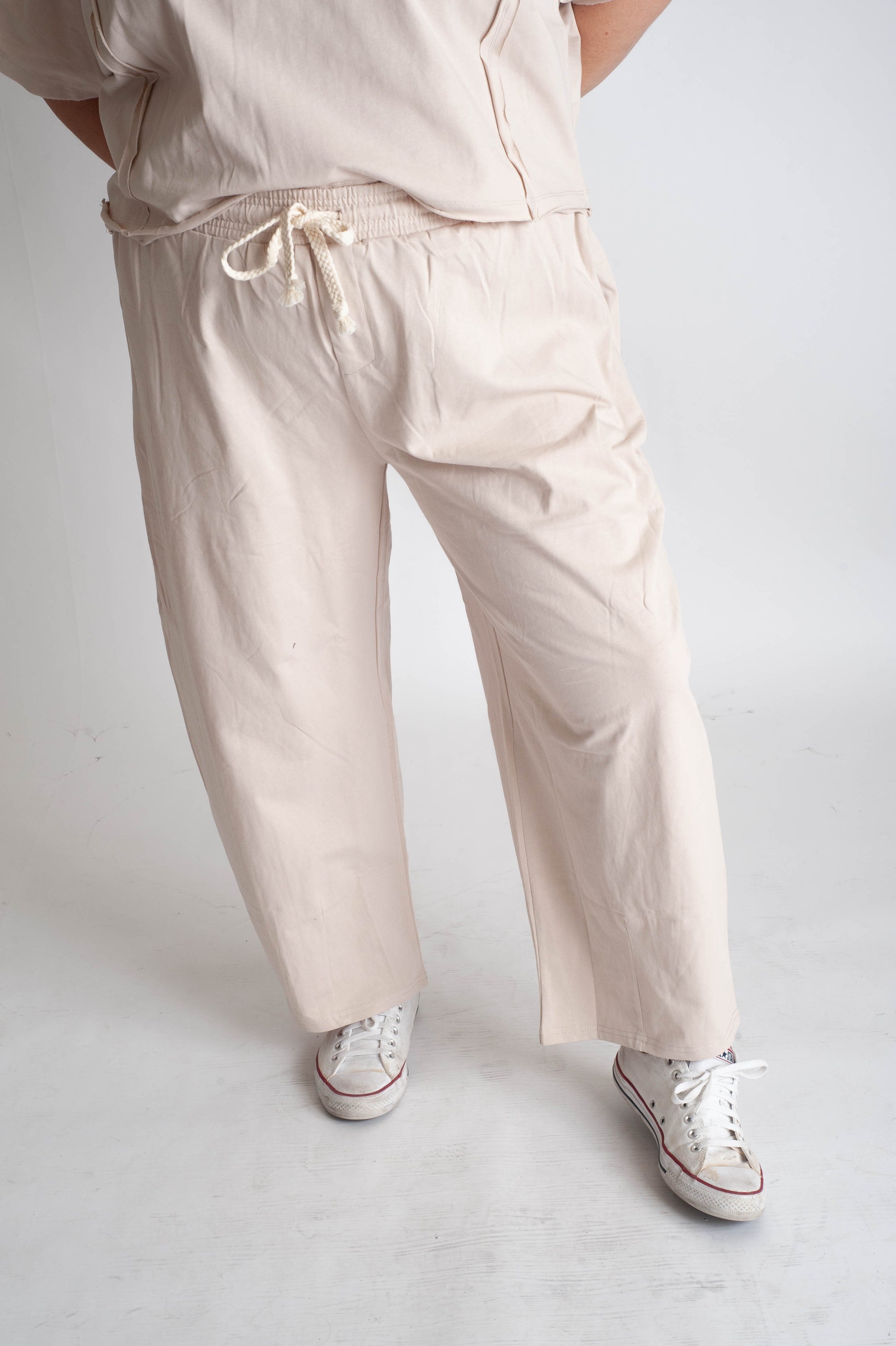 women wearing beige track pants