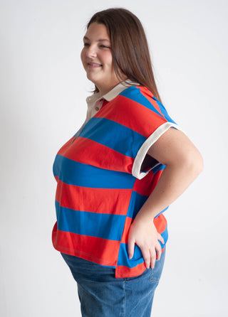 Person wearing a red and blue striped shirt on a white background