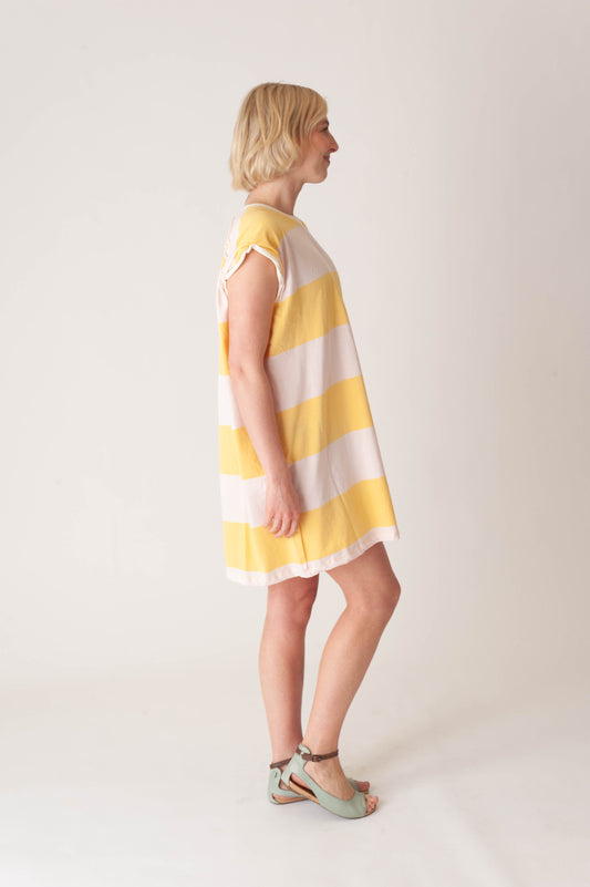 women wearing a striped yellow and pink dress on a white background