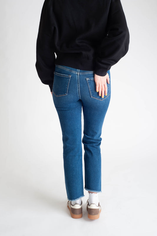 Women wearing a dark wash straight leg jean. 
