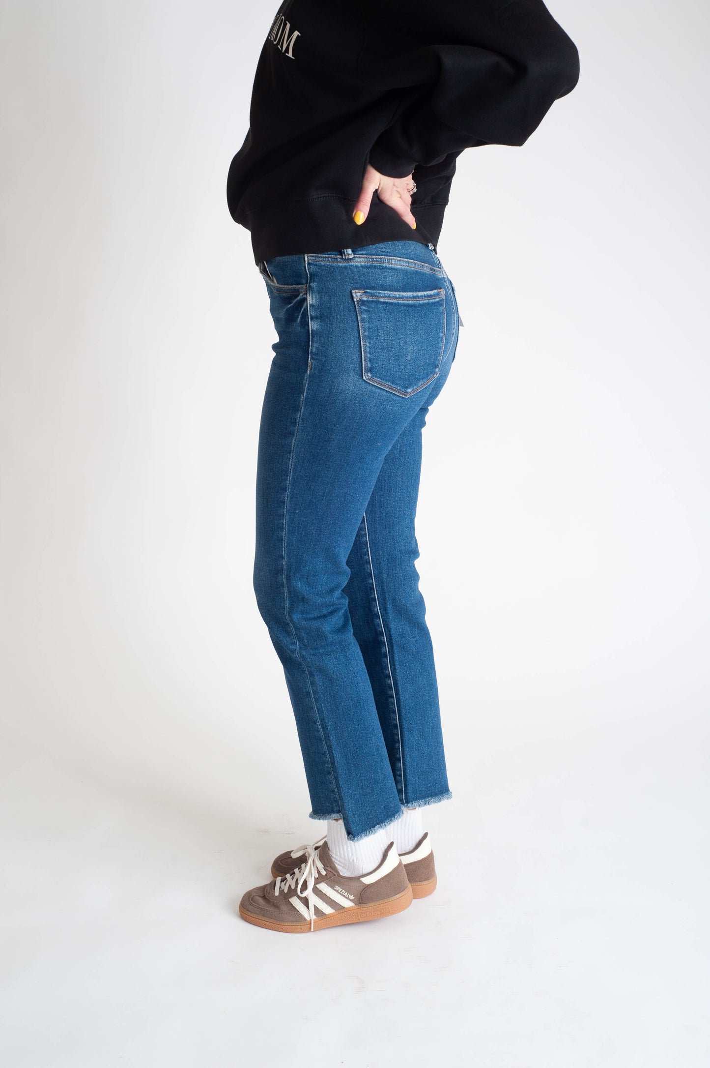 Women wearing a dark wash straight leg jean. 
