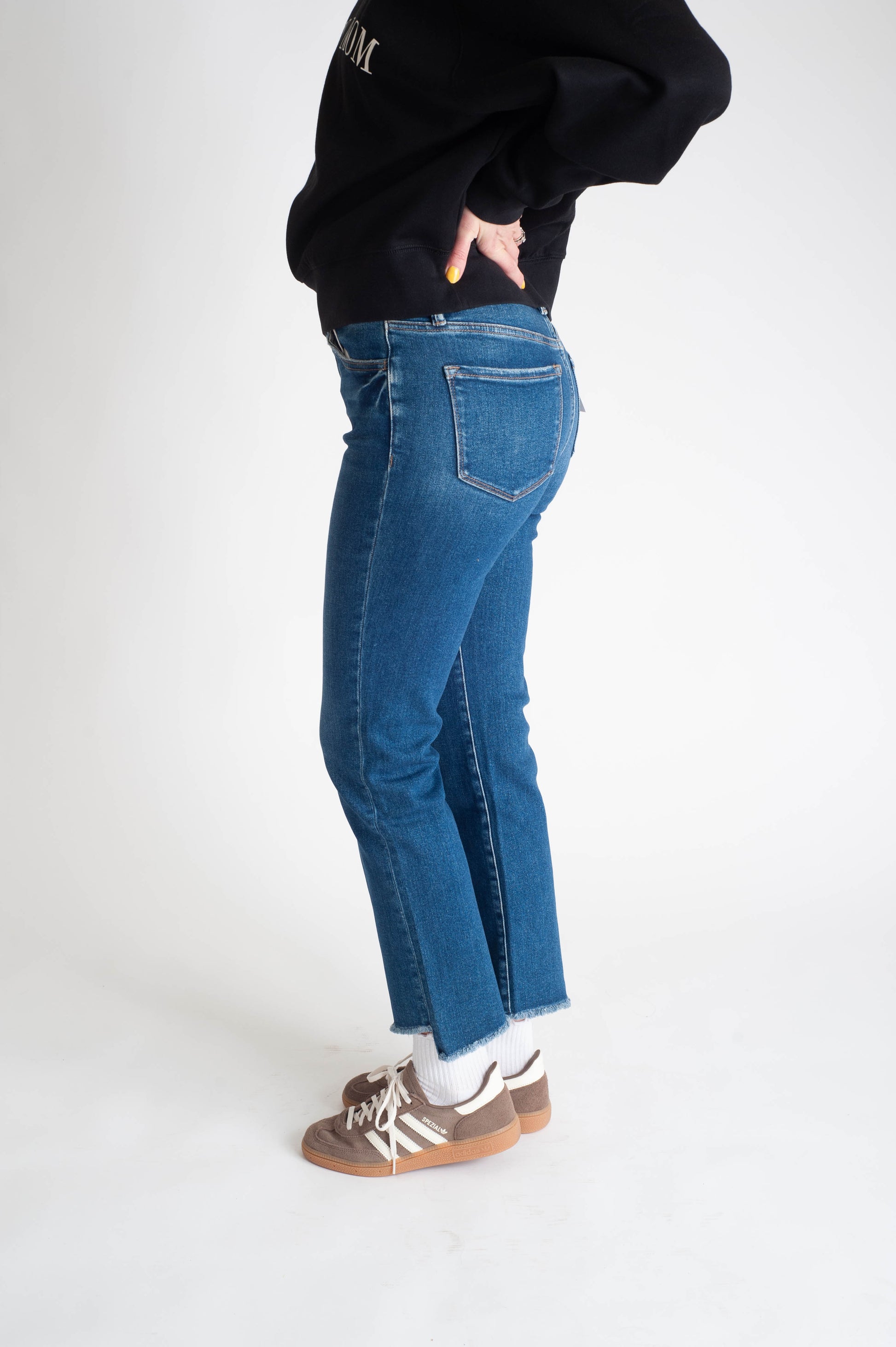 Women wearing a dark wash straight leg jean. 