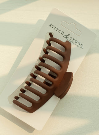 a plastic claw clip in a brown colour