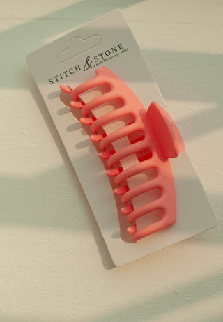 a plastic claw clip in a pink colour