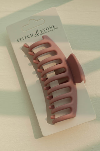 a plastic claw clip in a pink colour