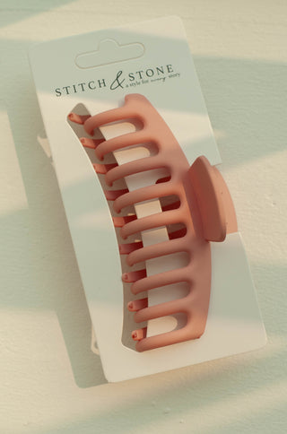 a plastic claw clip in a pink colour