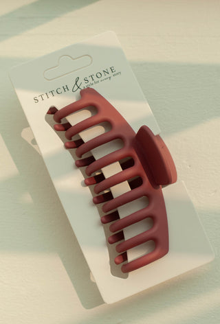 a plastic claw clip in a pink colour