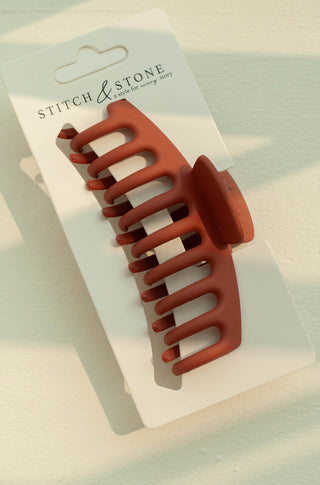 a plastic claw clip in a orange colour