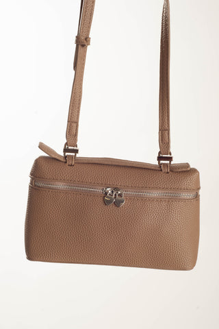 A tan pebbled leather crossbody handbag with a front zippered pocket and a top zipper, shown against a plain white background.