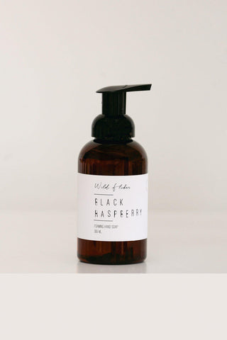 Brown bottle with pump and 'Black Raspberry' label on a white background